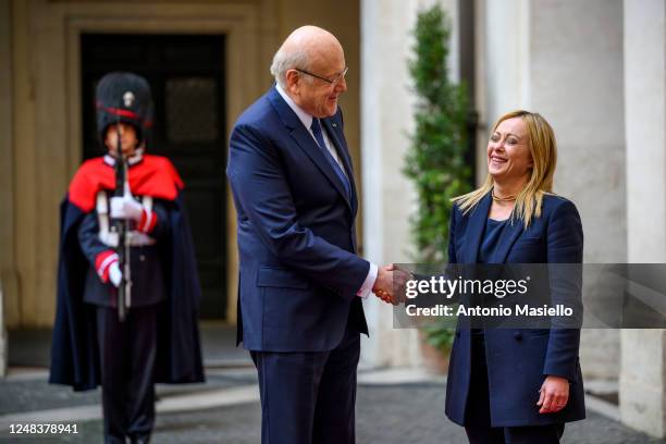 Italian Prime Minister Giorgia Meloni and Lebanese Prime Minister Najib Mikati shake hands before their meeting at Palazzo Chigi, during his official...