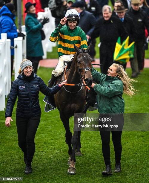 Gloucestershire , United Kingdom - 16 March 2023; Jockey Mark Walsh and Sire Du Berlais are led into the winners enclosure by Camilla Sharples, left,...