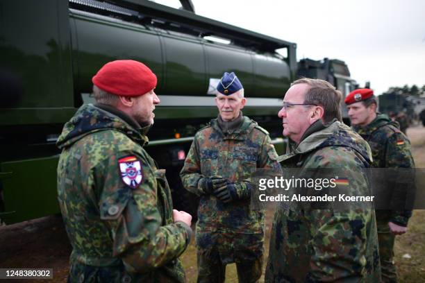 German Defence Minister Boris Pistorius looks on by soldiers of the NBC defence squad while visiting the joint support service of the Bundeswehr, the...