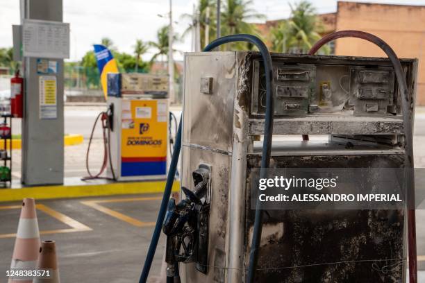 Burnt gas station is seen in Natal, Rio Grande do Norte state, Brazil on March 16, 2023. - Gang members torched cars, shot up public buildings and...