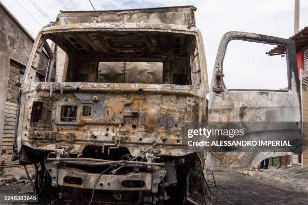 View of a burnt commercial truck in Natal, Rio Grande do Norte state, Brazil on 16 March 2023. - Gang members torched cars, shot up public buildings...