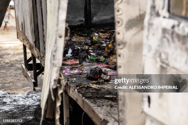 View of a burnt commercial truck in Natal, Rio Grande do Norte state, Brazil on 16 March 2023. - Gang members torched cars, shot up public buildings...