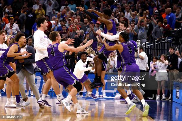 Players of the Furman Paladins celebrate their 68-67 victory against the Virginia Cavaliers in the first round of the NCAA Men's Basketball...