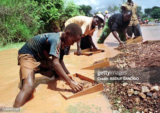 Man look into their sifter to find a diamond stone, 12 June 2001 in Tortya, about 500 kilometres north of Ivory Coast's main city Abidjan. The...