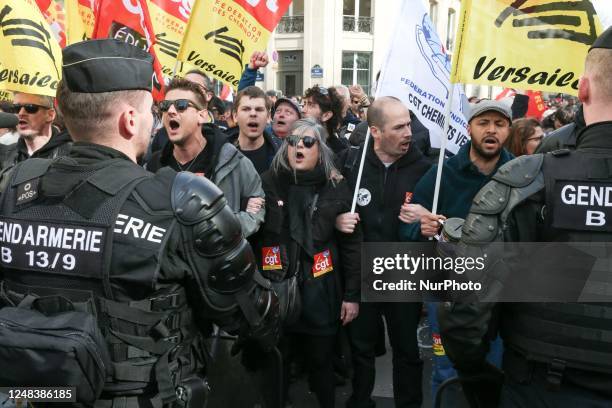 Demonstrators gather in front of the National Assembly before the French government pushed a pensions reform through parliament without a vote, using...