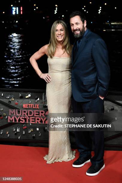 Actress Jennifer Aniston poses wih US Actor Adam Sandler as they arrive for the Premiere of the movie Murder Mystery 2 released by Netflix, in Paris,...