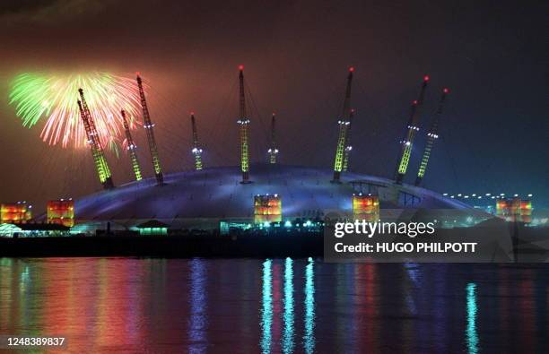 Fireworks light up the sky 01January 2000 on the strike of midnight as low cloud threatens to engulf Britain's flagship millennium dome. The midnight...