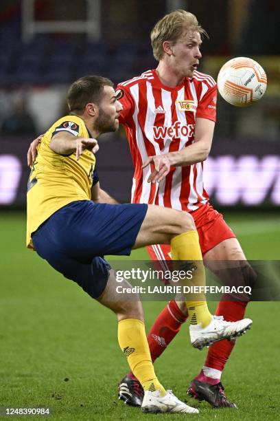 Union's Bart Nieuwkoop and Berlin's Morten Thorsby fight for the ball during a soccer game between Belgian Royale Union Saint-Gilloise and German...