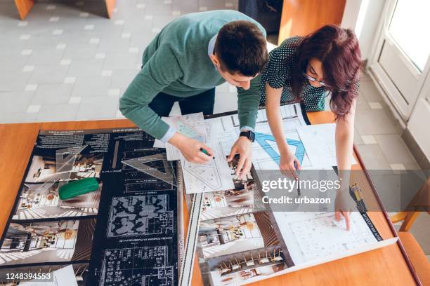 architects working with blueprint - interior designer stock pictures, royalty-free photos & images