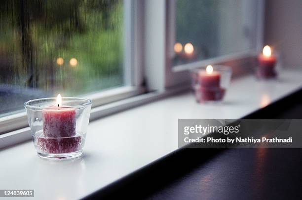 raining in june - tea light stock pictures, royalty-free photos & images