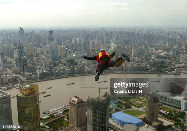 Parachutist leaps into air from 421-metre high Jinmao Tower during the 2004 Jinmao Tower International Base Jumping Show in Shanghai, 05 October...