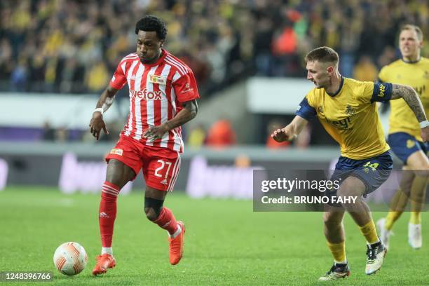 Berlin's Sheraldo Becker and Union's Siebe Van Der Heyden fight for the ball during a soccer game between Belgian Royale Union Saint-Gilloise and...