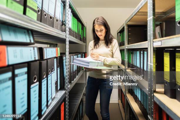 female business accountant controlling documents in finance file archive - filing documents stock pictures, royalty-free photos & images