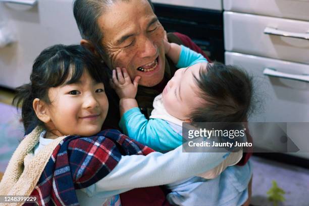 portrait of grand father and his grand daughter and grand son. - homecoming stock pictures, royalty-free photos & images