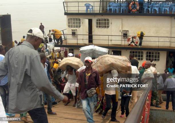 People work near a ferryboat on June 1, 2011 at the Beach, the port of Brazzaville, linking Congo to the Democratic Republic of Congo. The Beach is...