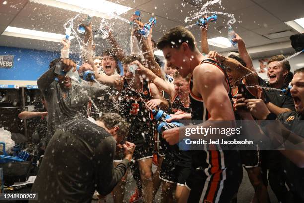 Princeton Tigers players spray head coach Mitch Henderson with water after a win against the Arizona Wildcats during the first round of the 2023 NCAA...