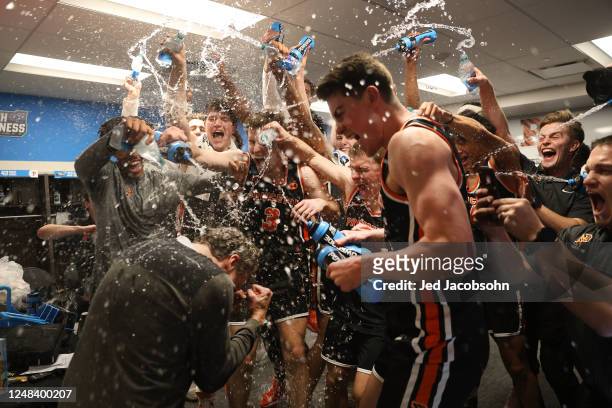 Princeton Tigers players spray head coach Mitch Henderson with water after a win against the Arizona Wildcats during the first round of the 2023 NCAA...