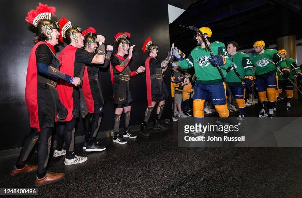 Fans of Roman Josi of the Nashville Predators high five him as he takes the ice for warmups prior to an NHL game against the Chicago Blackhawks at...