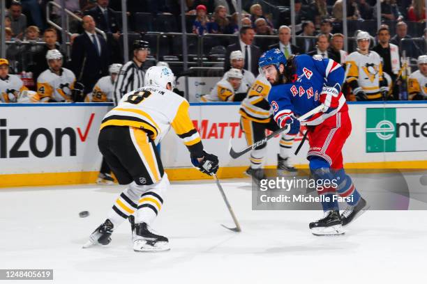 Mika Zibanejad of the New York Rangers shoots the puck against Brian Dumoulin of the Pittsburgh Penguins at Madison Square Garden on March 16, 2023...