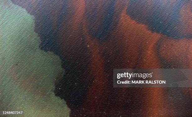 Mississippi River water meets sea water and an oil slick that has passsed inside of the protective barrier formed by the Chandeleur Islands, as...