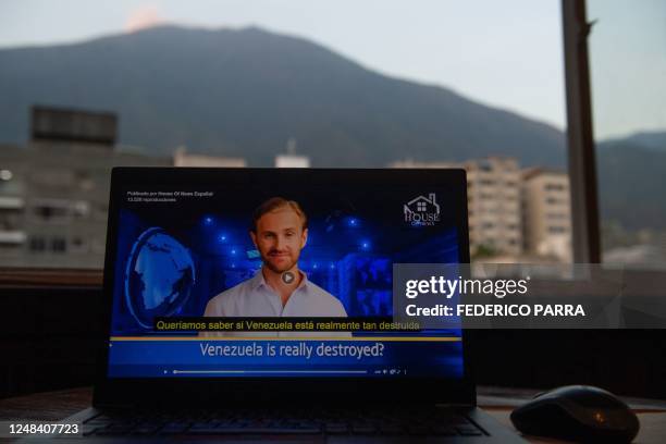 This illustration photo taken in Caracas on March 15 shows a laptop screen displaying a video of an AI avatar speaking during a broadcast of 'House...