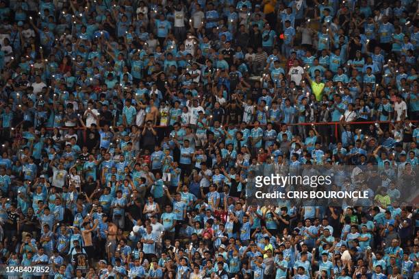 Supporters of Peru's Sporting Cristal cheer on the stands during the Copa Libertadores third round second leg football match between Peru's Sporting...