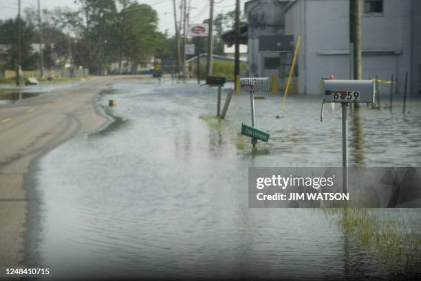 Water from the Bayou River stretches out to the street in Grand Bayou, Louisiana, on September 2, 2008 after Hurricane Gustav struck the small...