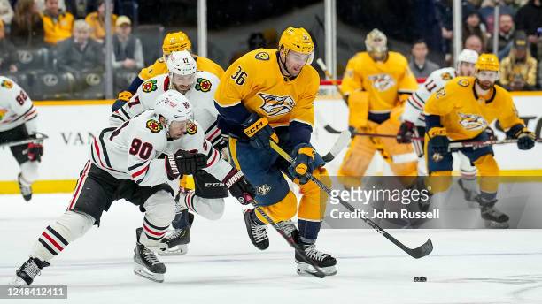 Cole Smith of the Nashville Predators skates against Tyler Johnson of the Chicago Blackhawks during an NHL game at Bridgestone Arena on March 16,...