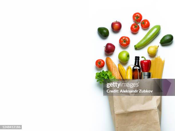 groceries in a paper bag. vegetarian and vegan food. donation and home delivery. banner. - delivery person on white stock pictures, royalty-free photos & images