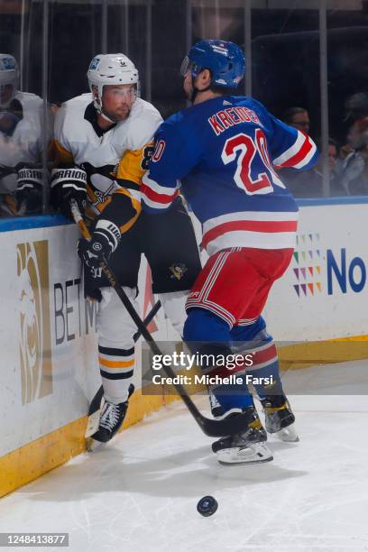 Chris Kreider of the New York Rangers throws a hit against Brian Dumoulin of the Pittsburgh Penguins at Madison Square Garden on March 16, 2023 in...