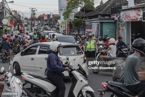 Motorcyclists travel on a street in Canggu, Bali, Indonesia, on Thursday, March 16, 2023. Foreign tourists in Bali wont be allowed to use motorcycles...