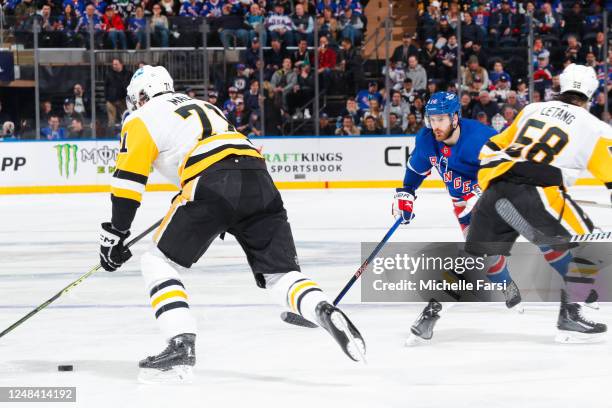 Tyler Motte of the New York Rangers defends against Evgeni Malkin of the Pittsburgh Penguins at Madison Square Garden on March 16, 2023 in New York...