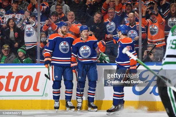 Mattias Janmark of the Edmonton Oilers celebrates after his first period goal against the Dallas Stars with Connor McDavid and Mattias Ekholm on...