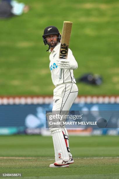 New Zealand's Devon Conway celebrates 50 runs on day one of the second Test cricket match between New Zealand and Sri Lanka at the Basin Reserve in...