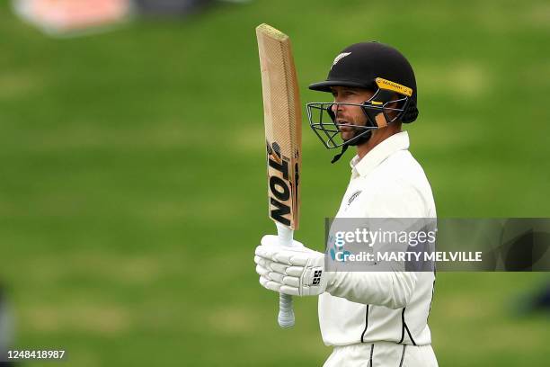 New Zealand's Devon Conway celebrates 50 runs on day one of the second Test cricket match between New Zealand and Sri Lanka at the Basin Reserve in...