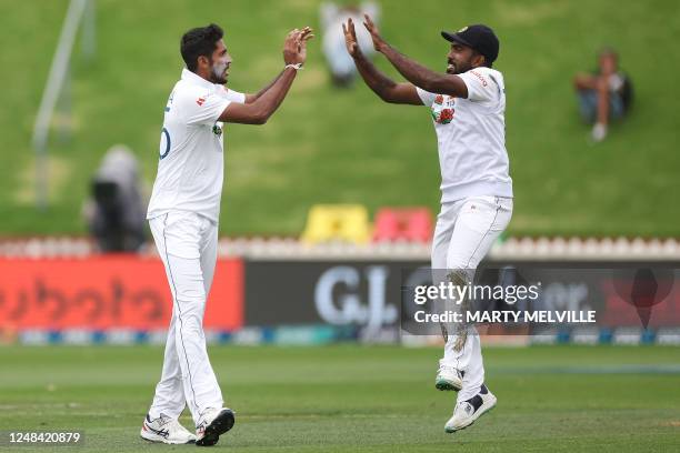 Sri Lanka's Kasun Rajitha celebrates New Zealand's Tom Latham being caught with teammate Asitha Fernando on day one of the second Test cricket match...