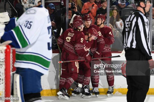 Travis Boyd of the Arizona Coyotes celebrates with Clayton Keller, Brett Ritchie and teammates after scoring a goal against the Vancouver Canucks...