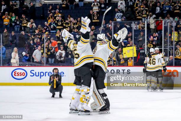 Goaltenders Linus Ullmark and Jeremy Swayman of the Boston Bruins celebrate following a 3-0 shutout victory over the Winnipeg Jets at the Canada Life...