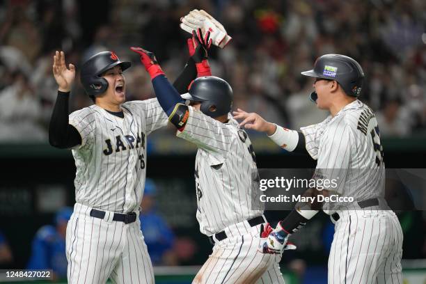 Kazuma Okamoto of Team Japan celebrates with teammates after hitting a three-run home run in the third inning during the 2023 World Baseball Classic...