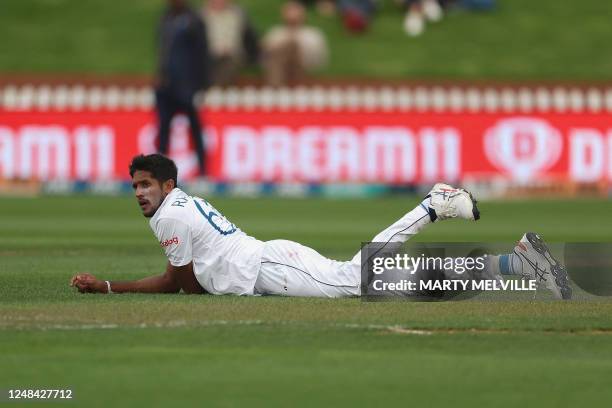 Sri Lanka's Kasun Rajitha takes a moment out after dropping a catch from New Zealand's Kane Williamson on day one of the second Test cricket match...