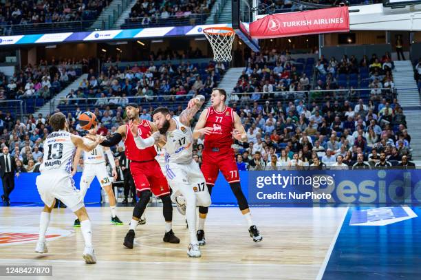 Vincent Poirier and Johannes Voigtmann and Brandon Davies in action during the basketball match between Real Madrid and EA7 Emporio Armani Olimpia...