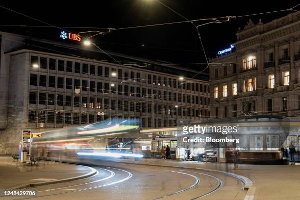 Group AG office building, left, alongside the Credit Suisse Group AG headquarters at night in Zurich, Switzerland, on Thursday, March 16, 2023. UBS...