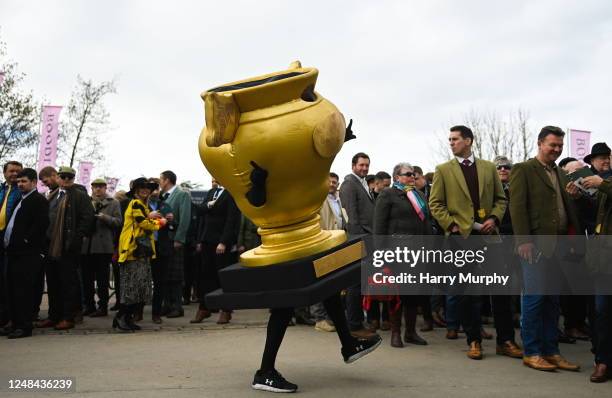 Gloucestershire , United Kingdom - 17 March 2023; A Gold Cup mascot dances before racing on day four of the Cheltenham Racing Festival at Prestbury...