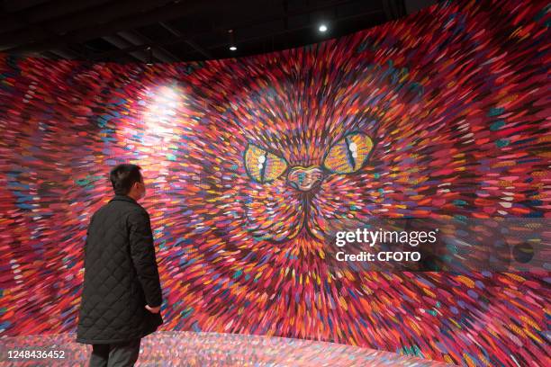 Citizen views Taiwanese artist IKKY's "Exotic Animals" art exhibition in Shanghai, China, March 17, 2023. The paintings and installations in the...