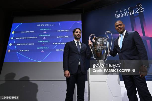 Champions League final ambassadors Turkish former footballer Hamit Altintop and Dutch former footballer Patrick Kluivert pose next to the draw result...