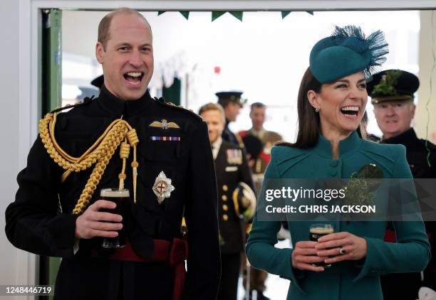 Britain's Prince William, Prince of Wales and Britain's Catherine, Princess of Wales enjoy a drink of Guinness with members of the 1st Battalion...