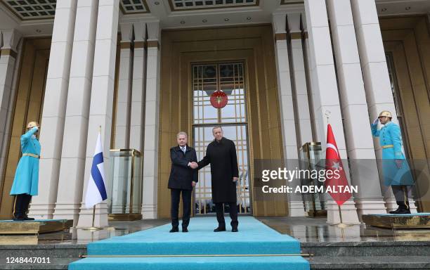 Turkish President Recep Tayyip Erdogan shakes hands with Finnish President Sauli Niinisto at the Presidential Complex in Ankara, on March 17, 2023.