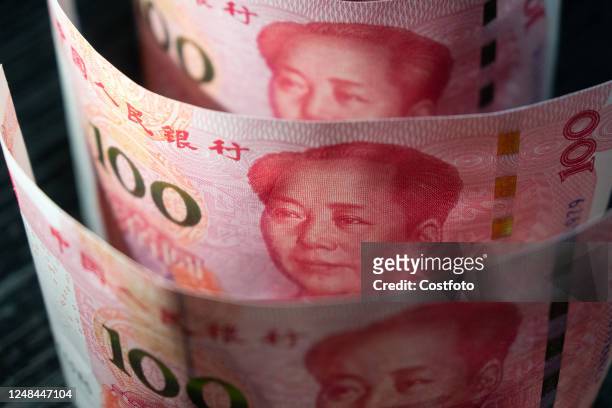 Photo taken on March 27, 2023 shows 100 yuan banknotes in Shanghai, China. The People's Bank of China decided to cut the reserve requirement ratio...