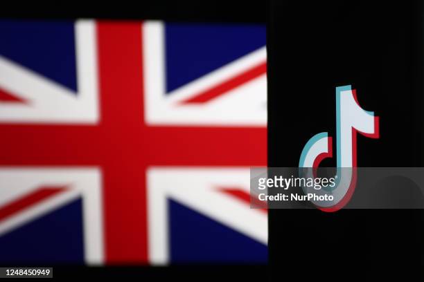 British flag displayed on a laptop screen and TikTok logo displayed on a phone screen are seen in this illustration photo taken in Krakow, Poland on...