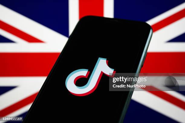 British flag displayed on a laptop screen and TikTok logo displayed on a phone screen are seen in this illustration photo taken in Krakow, Poland on...